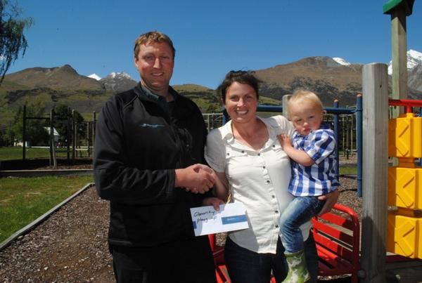 Dart River Jet Safaris Operations Manager Callan Grimmer hands over the locals day cheque to Alice and Tom Wilkins of Glenorchy Play Group.